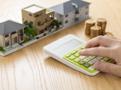 Man and house model calculating with calculator